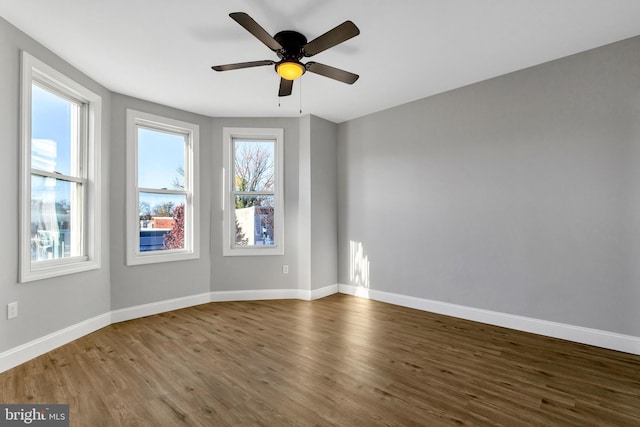 unfurnished room with ceiling fan and dark hardwood / wood-style floors