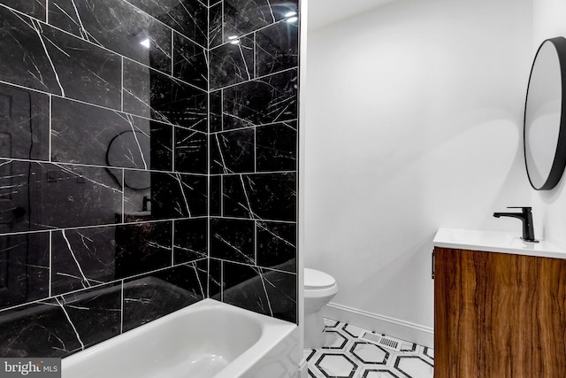 full bathroom with tile patterned flooring, vanity, tiled shower / bath combo, and toilet