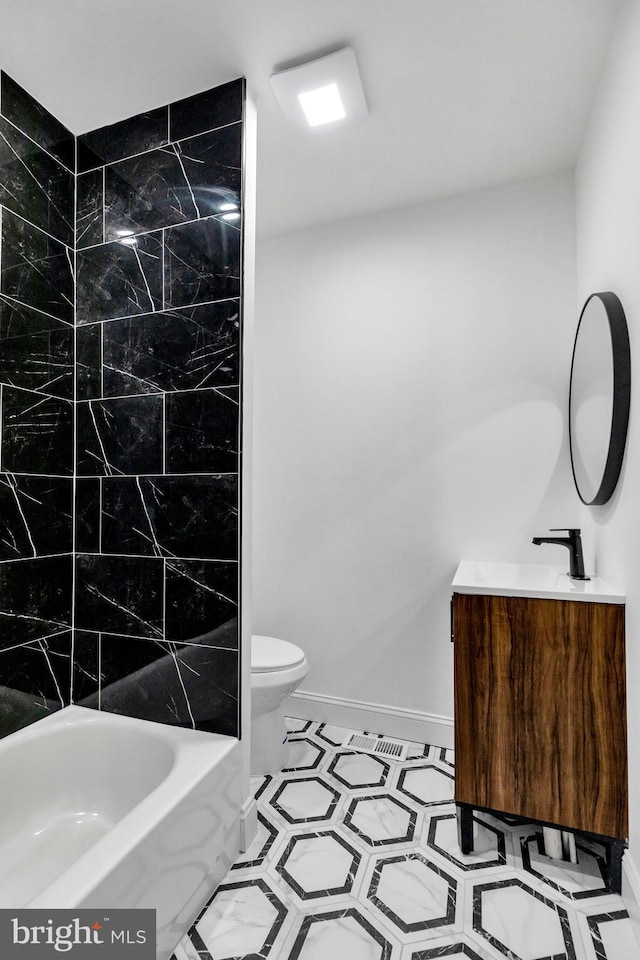 full bathroom with tile patterned floors, vanity, toilet, and tiled shower / bath combo