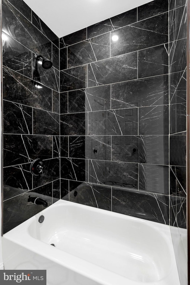 bathroom featuring tiled shower / bath