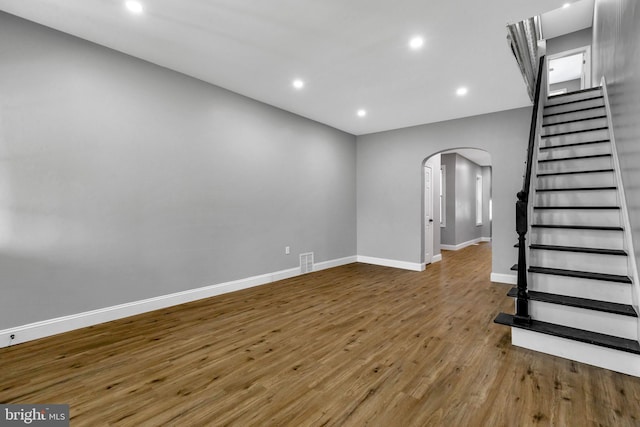 unfurnished living room with wood-type flooring