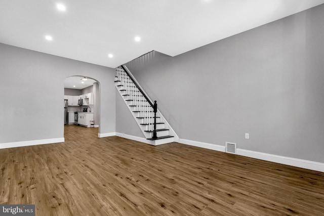 unfurnished living room featuring wood-type flooring