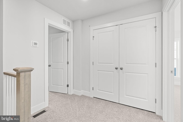 interior space featuring light colored carpet