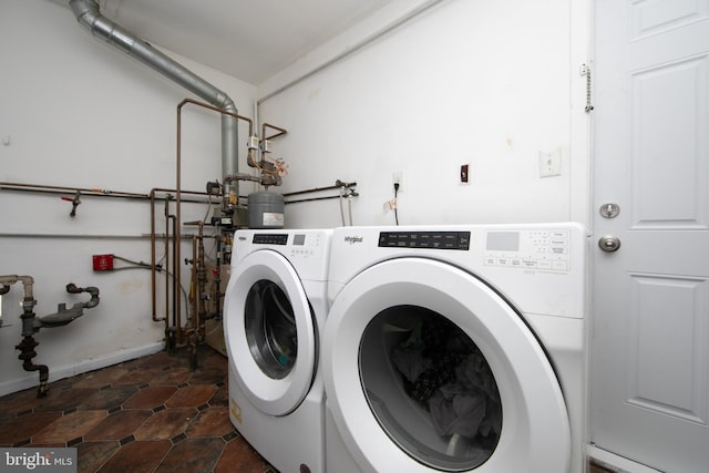 laundry area featuring laundry area, baseboards, and separate washer and dryer