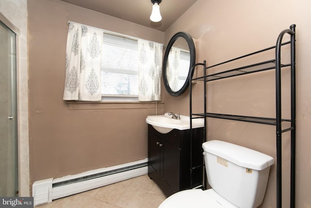 bathroom with toilet, tile patterned flooring, a baseboard heating unit, and vanity