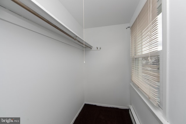 walk in closet with baseboard heating and attic access