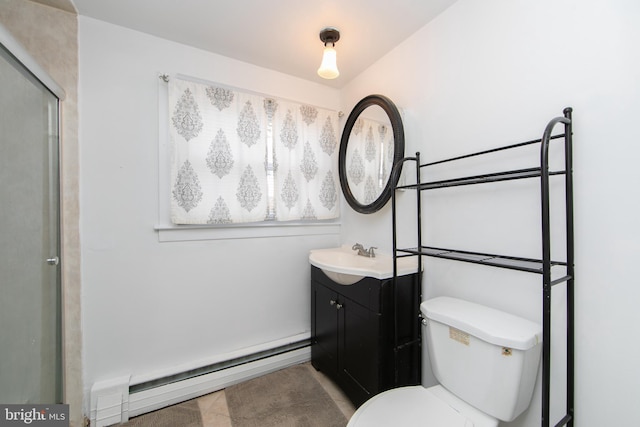 bathroom featuring toilet, baseboard heating, and vanity