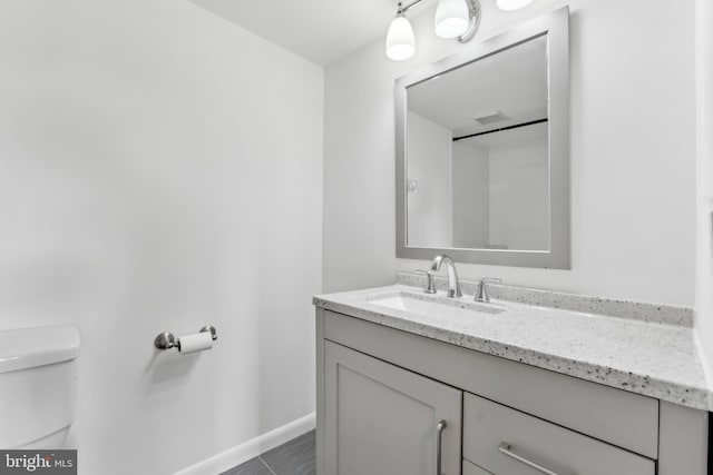 bathroom with tile patterned floors, vanity, and toilet