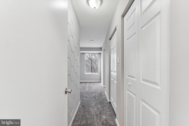 corridor with dark colored carpet