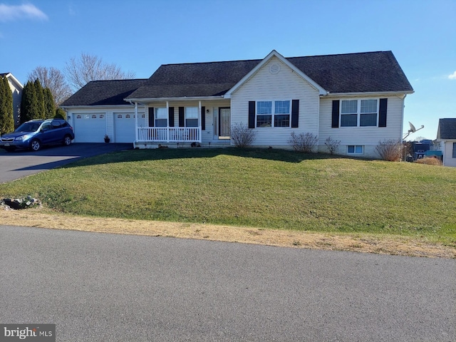 ranch-style house with covered porch, a garage, and a front yard