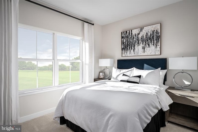 bedroom featuring light colored carpet