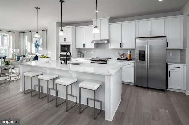 kitchen featuring white cabinets, sink, stainless steel appliances, and dark wood-type flooring