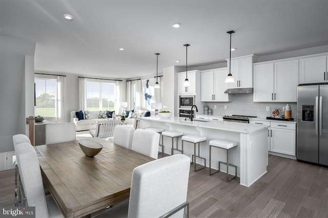 dining space with dark hardwood / wood-style floors and sink