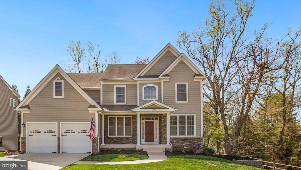 craftsman-style home featuring a front lawn and a garage