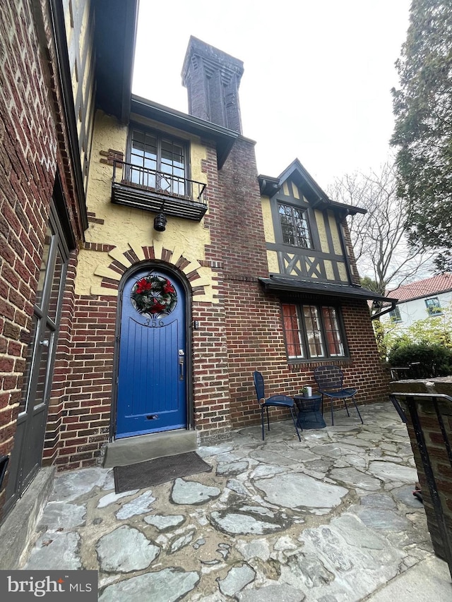 back of property featuring a balcony