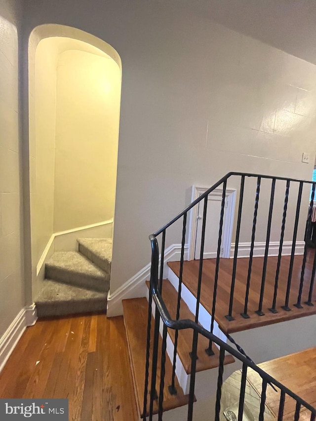 stairs featuring wood-type flooring