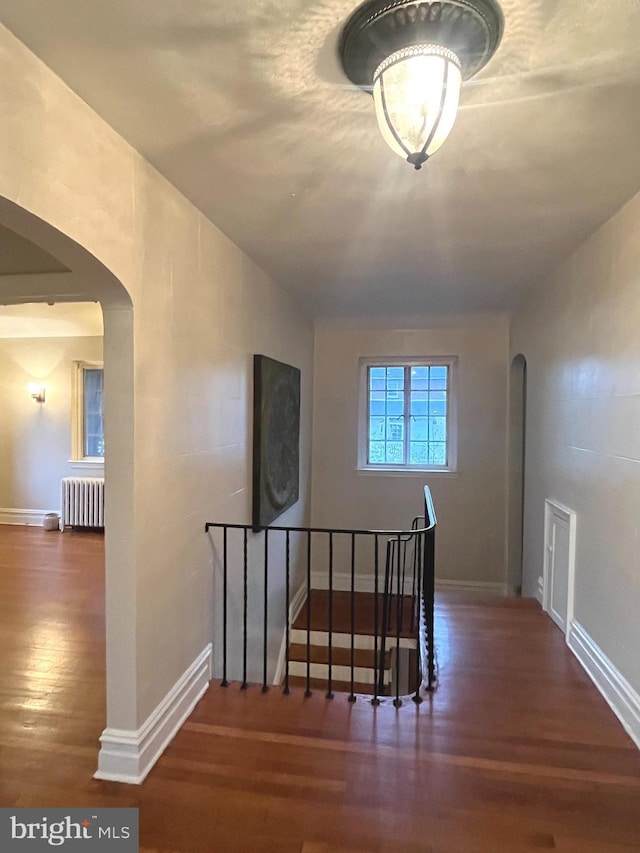 interior space featuring radiator and hardwood / wood-style flooring