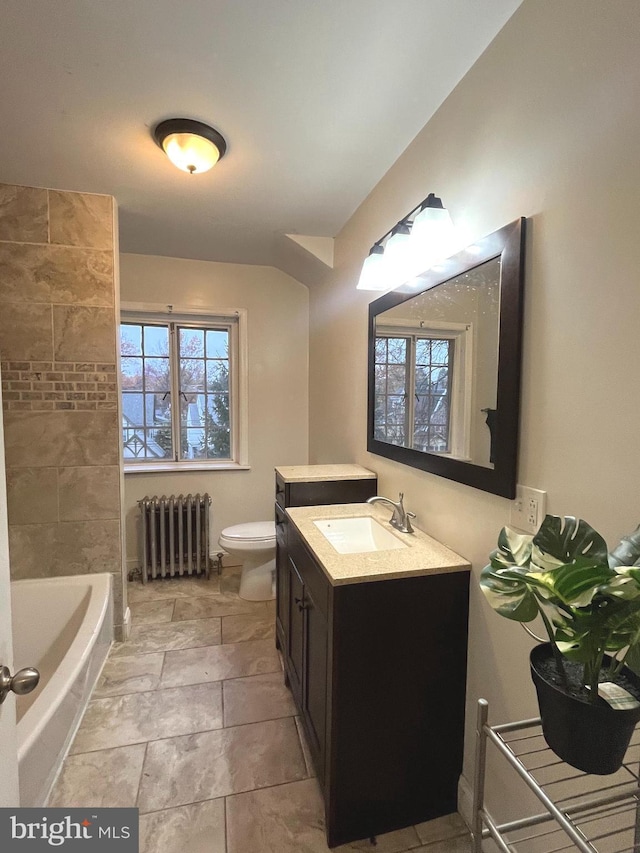 bathroom featuring radiator, vanity, and toilet