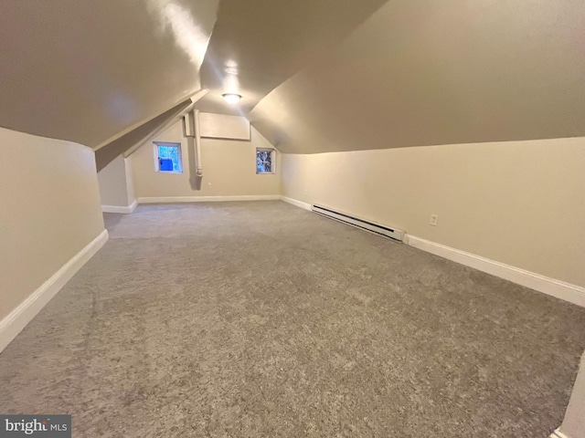 additional living space with baseboard heating, carpet, and lofted ceiling