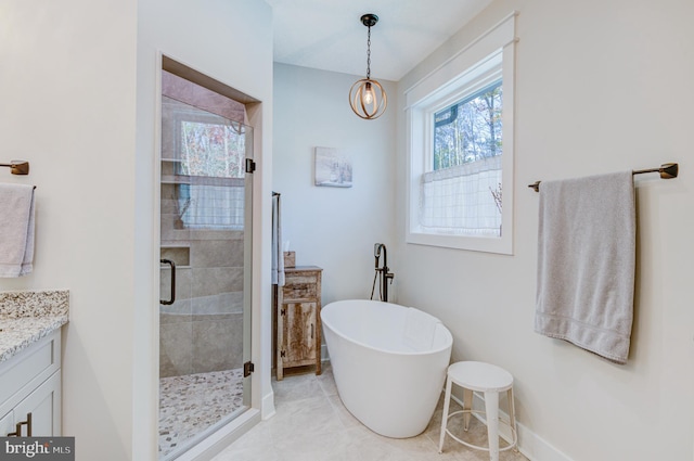 bathroom featuring vanity, independent shower and bath, and an inviting chandelier