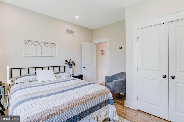 bedroom featuring a closet and light hardwood / wood-style floors