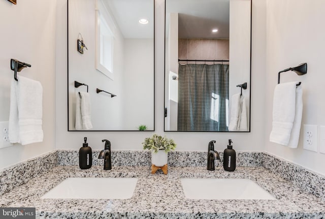 bathroom featuring a shower with shower curtain and vanity