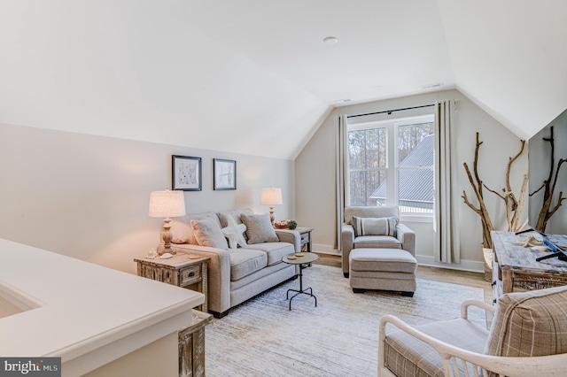 living room featuring light hardwood / wood-style floors and lofted ceiling