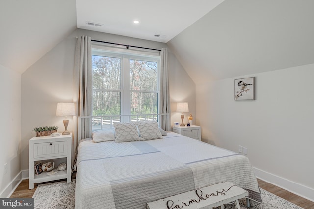 bedroom featuring wood-type flooring and lofted ceiling