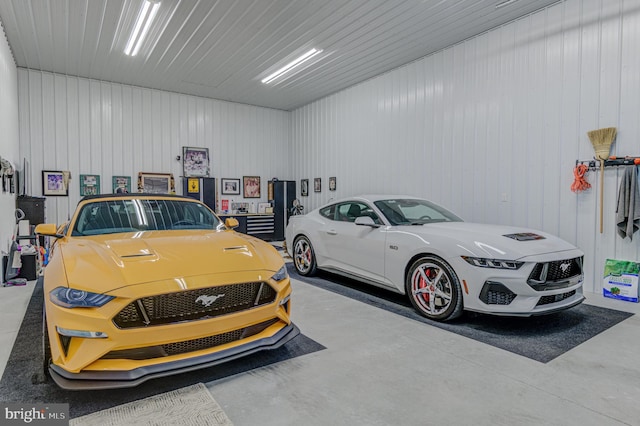 garage featuring wood walls