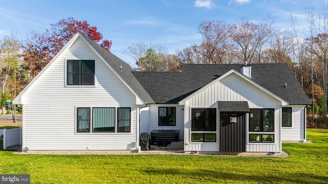 back of property featuring a lawn and a sunroom