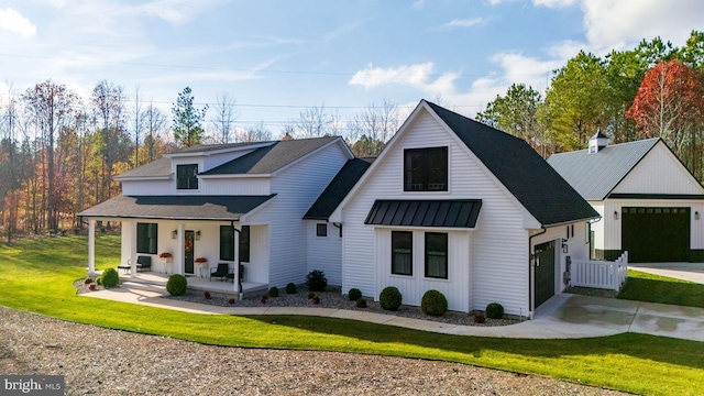 modern farmhouse with a porch and a front yard