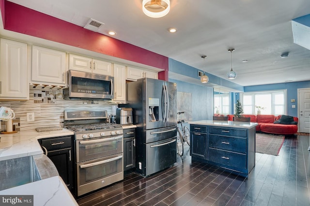 kitchen featuring white cabinets, decorative light fixtures, dark hardwood / wood-style flooring, and stainless steel appliances