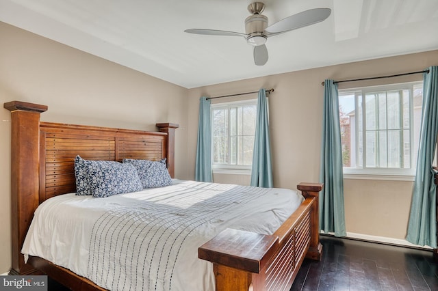 bedroom with dark hardwood / wood-style flooring and ceiling fan