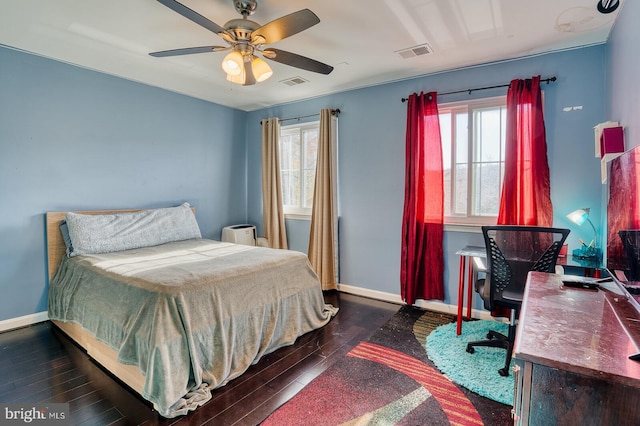 bedroom with dark hardwood / wood-style floors and ceiling fan