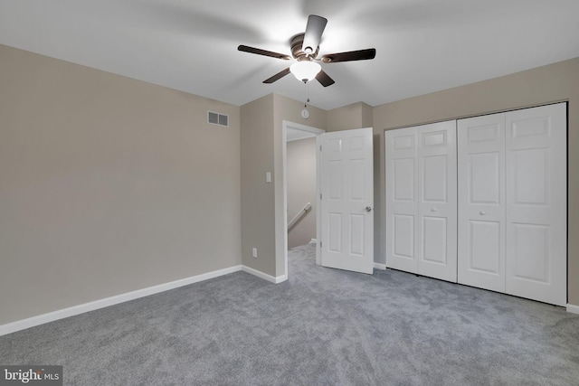 unfurnished bedroom with a closet, ceiling fan, and light colored carpet