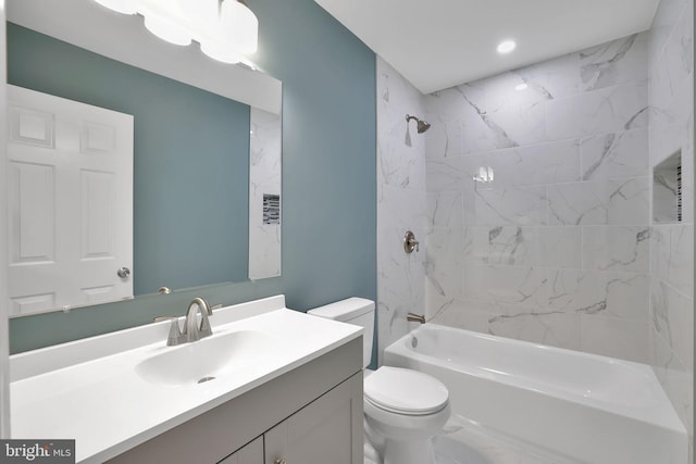 full bathroom featuring vanity, toilet, and tiled shower / bath