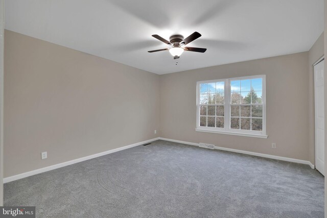 carpeted empty room with ceiling fan