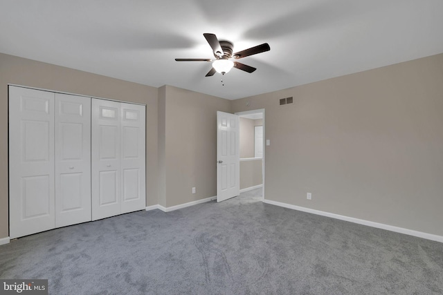 unfurnished bedroom featuring carpet flooring, a closet, and ceiling fan