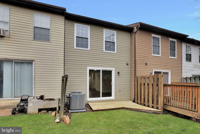 back of house featuring a lawn and central AC