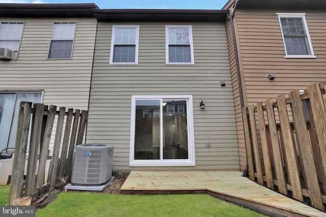 rear view of house with a deck and cooling unit