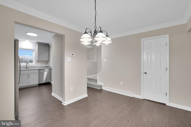 unfurnished dining area featuring crown molding, sink, dark wood-type flooring, and an inviting chandelier