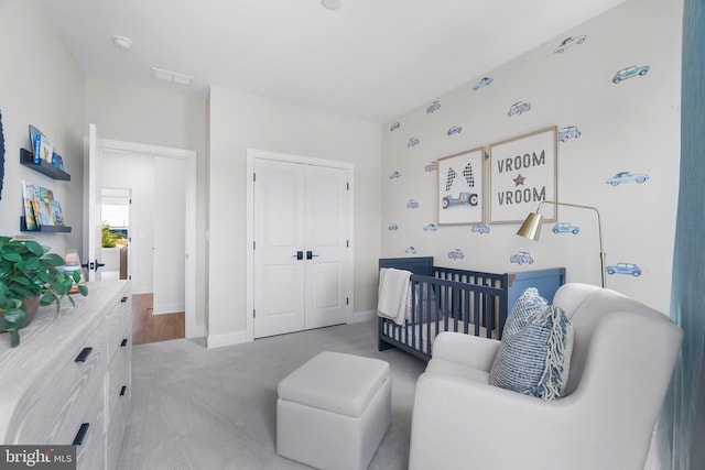 bedroom with carpet flooring and a crib