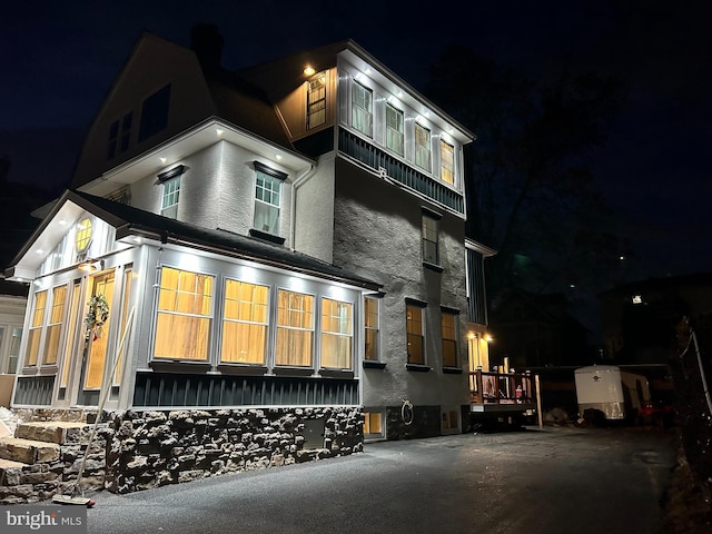 view of property exterior at night