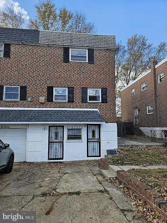 rear view of property with a garage