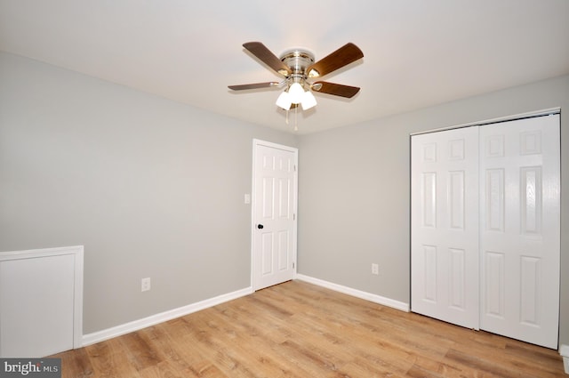 unfurnished bedroom featuring ceiling fan, a closet, and light hardwood / wood-style flooring