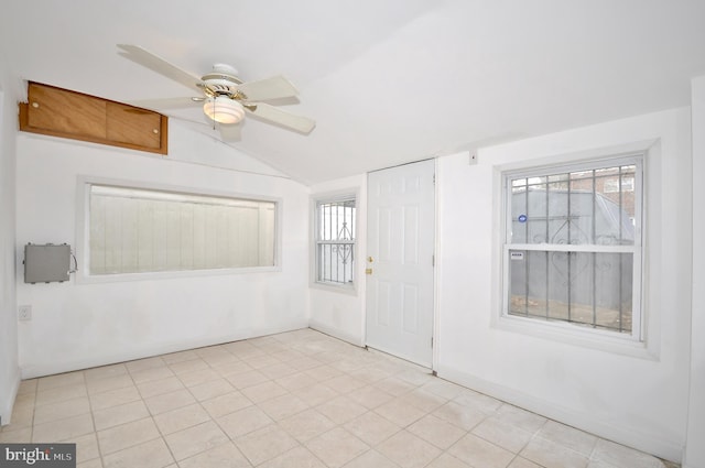 empty room with ceiling fan and lofted ceiling