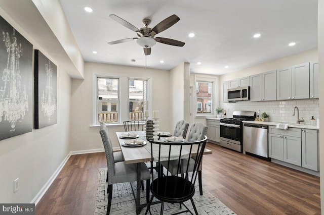 dining area with dark hardwood / wood-style floors, ceiling fan, and sink