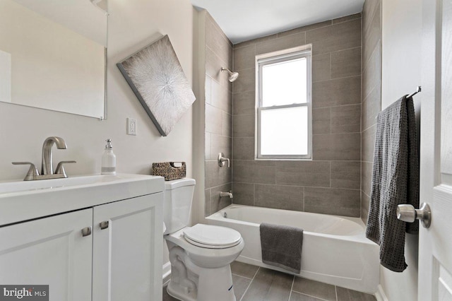 full bathroom with tiled shower / bath combo, toilet, and vanity