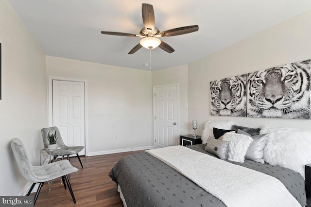 bedroom with dark hardwood / wood-style flooring and ceiling fan