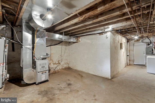 basement featuring gas water heater, electric panel, heating unit, and washer / clothes dryer